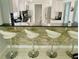 Stylish kitchen featuring a breakfast bar with seating, stainless steel appliances, and modern finishes at 1819 Shore S Dr # 318, South Pasadena, FL 33707