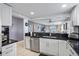 Modern kitchen boasts white cabinetry, black countertops, stainless steel appliances and an open design at 1819 Shore S Dr # 318, South Pasadena, FL 33707