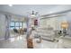 Bright living room with tile floors, ceiling fan, large windows, and comfortable seating at 1819 Shore S Dr # 318, South Pasadena, FL 33707
