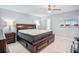 Spacious main bedroom featuring an elegant wood bed frame, tile floors, and a neutral color scheme at 1819 Shore S Dr # 318, South Pasadena, FL 33707