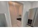 Charming pantry featuring white cabinetry, black countertops, and tiled flooring at 1819 Shore S Dr # 318, South Pasadena, FL 33707
