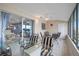 Bright sunroom with waterfront view, tile flooring, and modern furniture, leading to living area at 1819 Shore S Dr # 318, South Pasadena, FL 33707