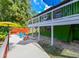 Bright back deck with white railing, colorful patio seating, and umbrella at 4617 John Moore Rd, Brandon, FL 33511