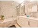 Elegant bathroom with double vanity, glass shower, and marble tile at 4617 John Moore Rd, Brandon, FL 33511