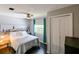 Well-lit bedroom with hardwood floors, ceiling fan, and closet space for storage at 4617 John Moore Rd, Brandon, FL 33511