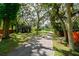 Spacious front yard with mature trees and lush greenery providing a serene setting at 4617 John Moore Rd, Brandon, FL 33511