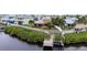 Aerial view of a home highlighting a spacious yard, private dock, and serene waterfront setting at 6404 Key Island Ave, Apollo Beach, FL 33572