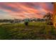 Expansive backyard featuring lush green grass, a white fence, and waterfront views providing serene outdoor space at 6404 Key Island Ave, Apollo Beach, FL 33572