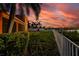 Waterfront backyard with lush landscaping and a white fence at 6404 Key Island Ave, Apollo Beach, FL 33572