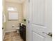 Bathroom featuring a granite countertop, tiled floor, and modern fixtures at 6404 Key Island Ave, Apollo Beach, FL 33572
