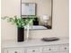 Bedroom dresser featuring modern decor and a stylish decorative mirror at 6404 Key Island Ave, Apollo Beach, FL 33572