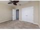 Bedroom with neutral walls, carpeted flooring, closet, and a ceiling fan at 6404 Key Island Ave, Apollo Beach, FL 33572