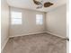 Neutral bedroom with ceiling fan and carpeted flooring is brightened by natural light at 6404 Key Island Ave, Apollo Beach, FL 33572