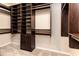 Custom walk-in closet with shelving, rods, and carpet flooring at 6404 Key Island Ave, Apollo Beach, FL 33572