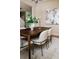 Elegant dining room featuring a dark wood table, upholstered chairs, and a modern art piece at 6404 Key Island Ave, Apollo Beach, FL 33572