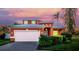 Charming two-story home featuring an attached garage, beautiful landscaping, and a colorful sunset backdrop at 6404 Key Island Ave, Apollo Beach, FL 33572
