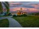 Two-story house with orange exterior, landscaped lawn, and a paved driveway at 6404 Key Island Ave, Apollo Beach, FL 33572