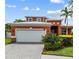 Charming single-Gathering home featuring a paver driveway, two-car garage, and a welcoming front yard at 6404 Key Island Ave, Apollo Beach, FL 33572