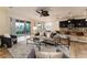 Bright and airy living room with modern furnishings that flows seamlessly into the open-concept kitchen and dining area at 6404 Key Island Ave, Apollo Beach, FL 33572
