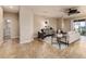 Open-concept living room with a sofa, accent chairs, stylish rug, and access to the outdoors at 6404 Key Island Ave, Apollo Beach, FL 33572