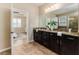 Main bathroom with double vanity, granite countertops, and private toilet at 6404 Key Island Ave, Apollo Beach, FL 33572