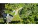 Aerial view showcasing a home with a large backyard, dock, and pond at 4617 John Moore Rd, Brandon, FL 33511