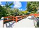 White wooden dock with red railing and colorful chairs overlooking the river at 4617 John Moore Rd, Brandon, FL 33511
