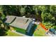 Aerial view of a green house with a deck, fire pit, and waterfront access at 4617 John Moore Rd, Brandon, FL 33511