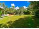 Large grassy backyard with a white fence and shed at 4617 John Moore Rd, Brandon, FL 33511