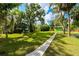 Pathway through a lush green backyard towards a dock at 4617 John Moore Rd, Brandon, FL 33511