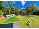 Landscaped backyard with artificial turf and walkway at 4617 John Moore Rd, Brandon, FL 33511
