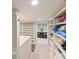Spacious walk-in closet with built-in shelving and a view into the bathroom at 4617 John Moore Rd, Brandon, FL 33511