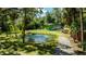 Charming green home with pond, fountain, and lush landscaping at 4617 John Moore Rd, Brandon, FL 33511