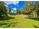 Green house and expansive backyard with trees and a pond at 4617 John Moore Rd, Brandon, FL 33511