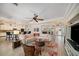 Open living room with a large sectional sofa, ceiling fan, and hardwood floors at 824 Citrus Wood Ln, Valrico, FL 33594