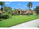 Home exterior with lush landscaping and palm trees at 824 Citrus Wood Ln, Valrico, FL 33594