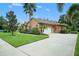 Beautiful home exterior with landscaped yard and driveway at 824 Citrus Wood Ln, Valrico, FL 33594