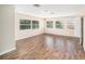 Bright bonus room with wood-look floors and multiple windows at 1704 Cresswell Manor Ct, Dover, FL 33527