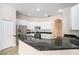 Modern kitchen with stainless steel appliances and dark granite countertops at 1704 Cresswell Manor Ct, Dover, FL 33527