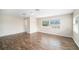 Large bedroom with wood-look floors and multiple windows at 1704 Cresswell Manor Ct, Dover, FL 33527