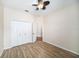 Bedroom with double door closet and wood-look floors at 1704 Cresswell Manor Ct, Dover, FL 33527