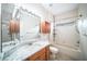 Bathroom with granite countertop, shower, and built-in shelves at 1704 Cresswell Manor Ct, Dover, FL 33527