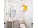 Clean bathroom with pedestal sink, toilet and yellow cabinet at 1704 Cresswell Manor Ct, Dover, FL 33527