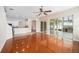 Living room with hardwood floors, kitchen view, and access to covered patio at 1704 Cresswell Manor Ct, Dover, FL 33527