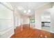 Bright dining room with hardwood floors and views into the kitchen and Gathering room at 1704 Cresswell Manor Ct, Dover, FL 33527