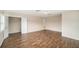 Spacious bedroom with wood-look floors and access to a storage room at 1704 Cresswell Manor Ct, Dover, FL 33527