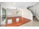 Open living room with hardwood floors, stairs, and access to backyard at 1704 Cresswell Manor Ct, Dover, FL 33527