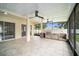 Outdoor kitchen with screened enclosure and ceiling fans at 1704 Cresswell Manor Ct, Dover, FL 33527