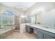 Bathroom features granite countertops, dual sinks, and a soaking tub at 1704 Cresswell Manor Ct, Dover, FL 33527