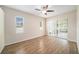 Bright bedroom with wood-look floors and sliding glass doors to patio at 1704 Cresswell Manor Ct, Dover, FL 33527